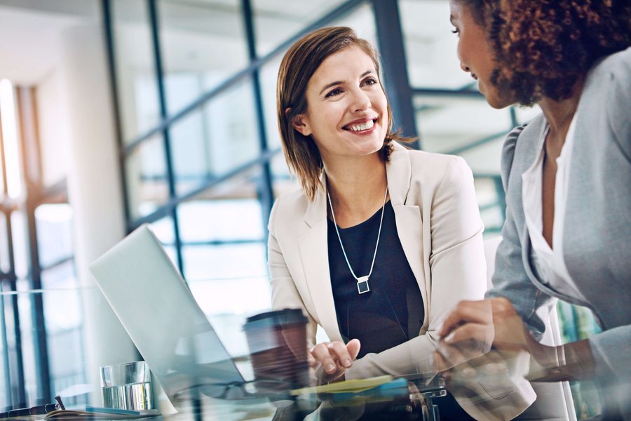 Two women discussing financial planning documents