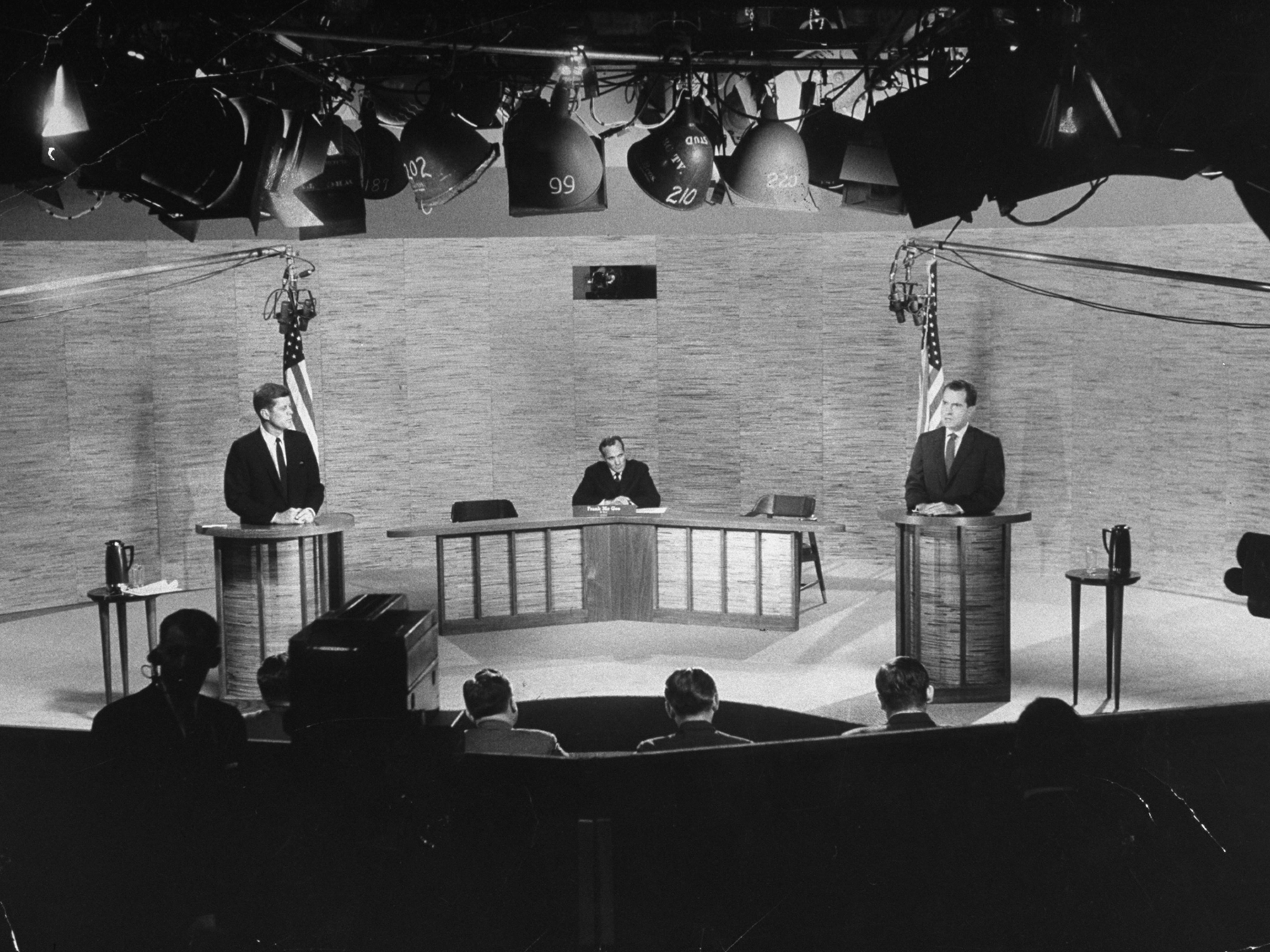 political debate podium with media cameras