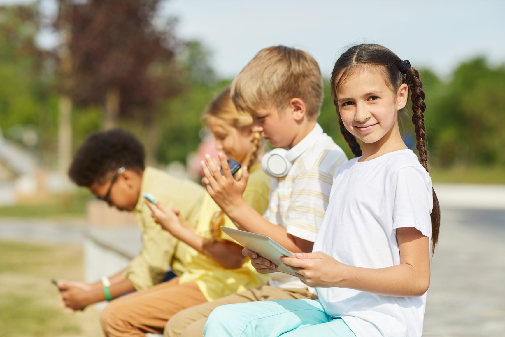 students using gadgets outdoors