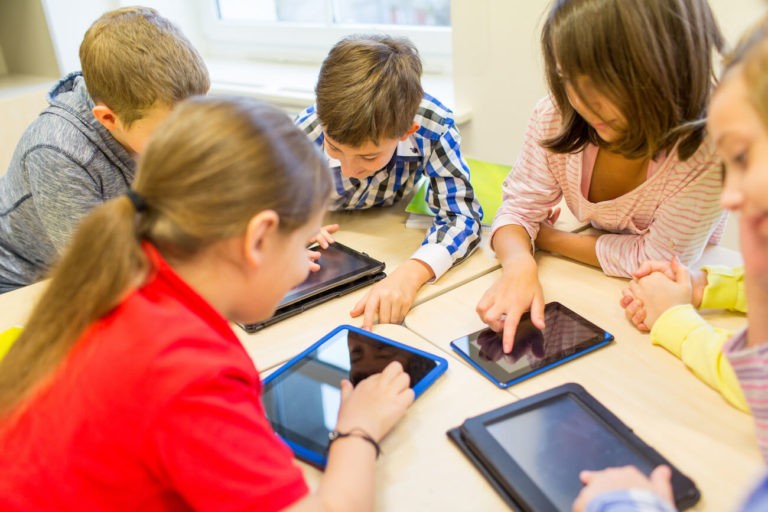 students using tablets in classroom
