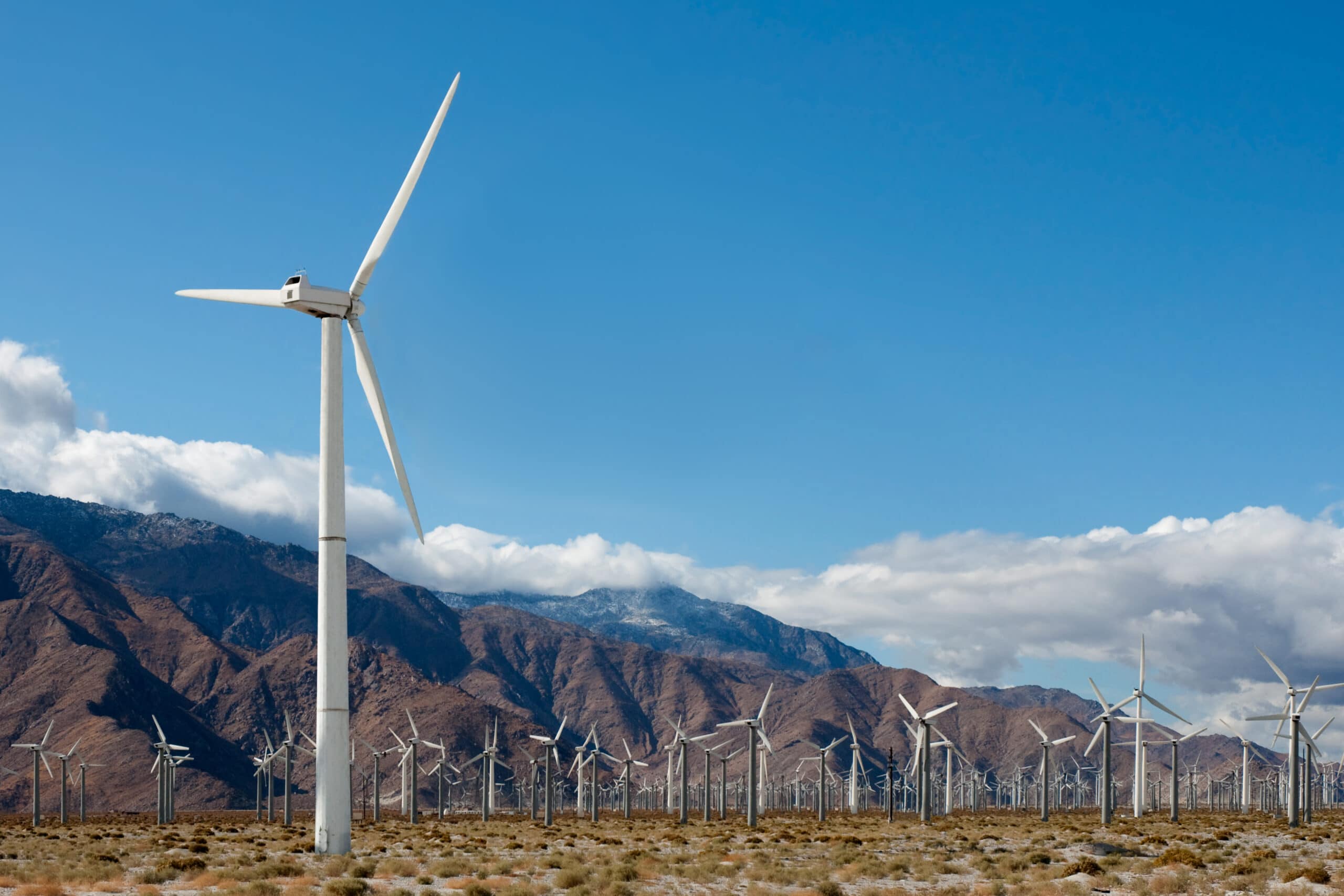 scenic landscape with renewable energy wind turbines and community