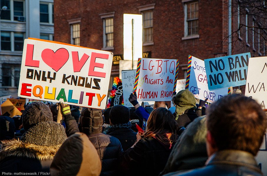 People at a rally holding signs advocating for LGBTQ rights