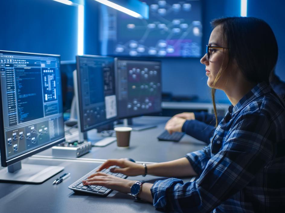 programmers working with computers and code on screens