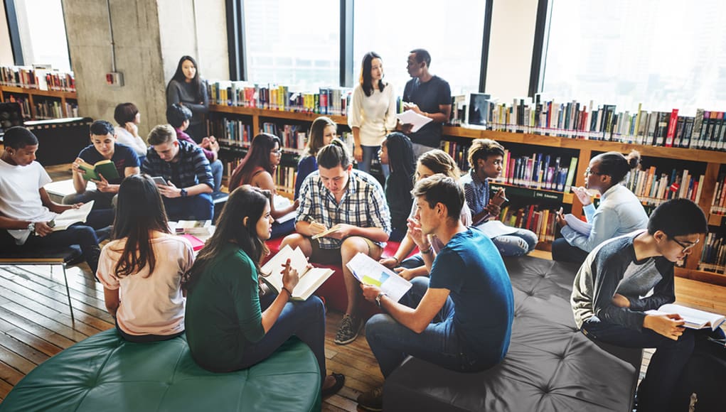 school campus with students studying