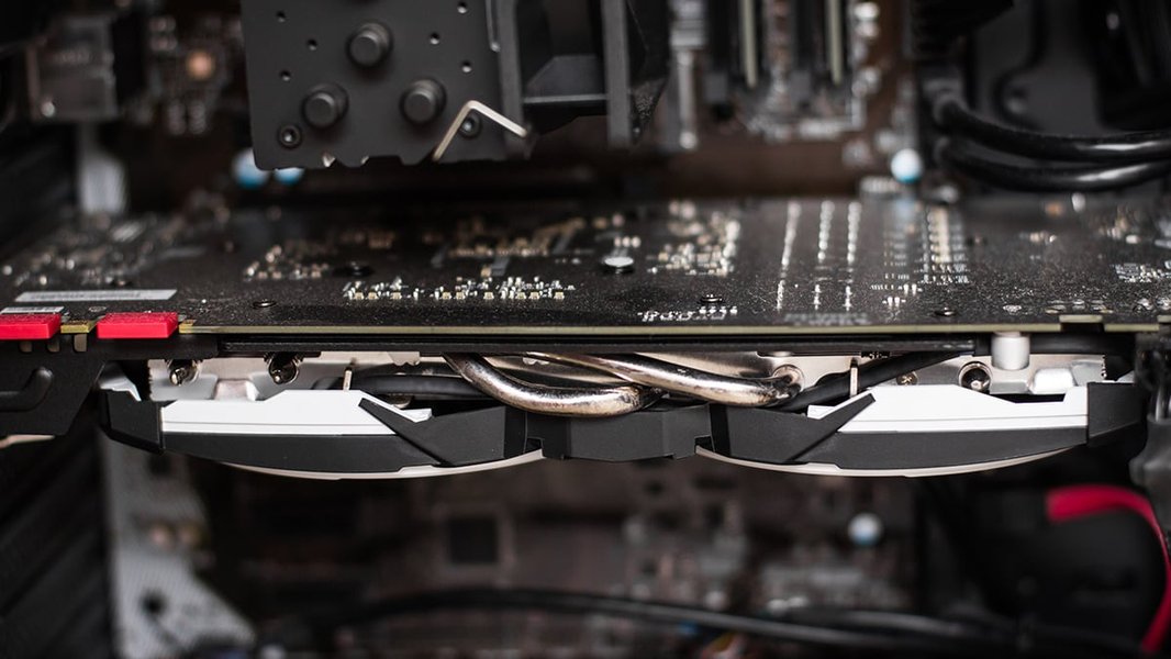 A close-up of a graphics card's cooling system, showing the heatsink and fans, with heat pipes visible.