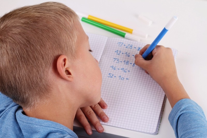 child doing math homework