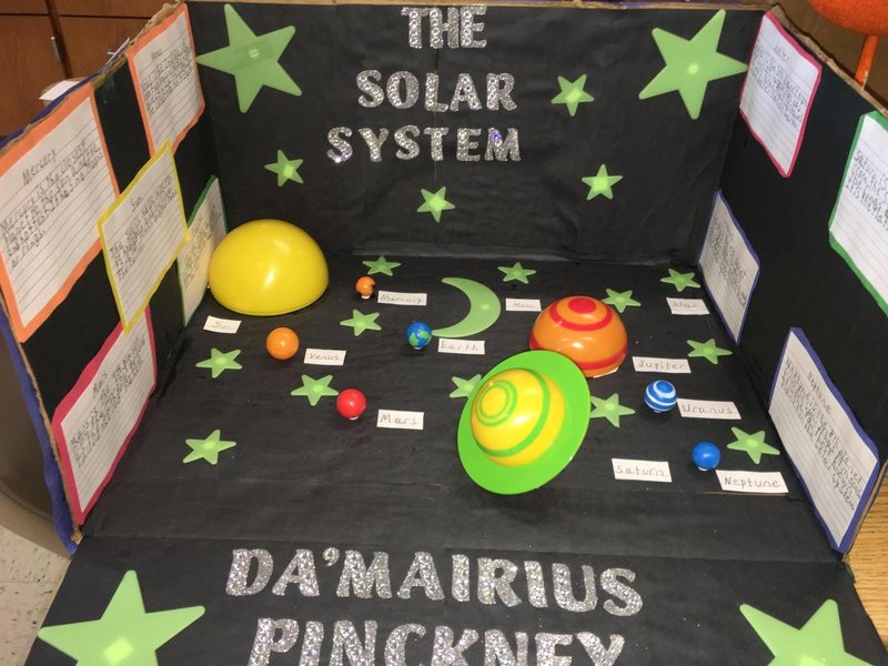 High school students presenting solar energy projects