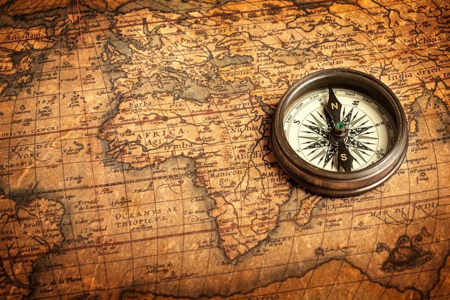 A collection of traditional navigation tools including an astrolabe and a compass.