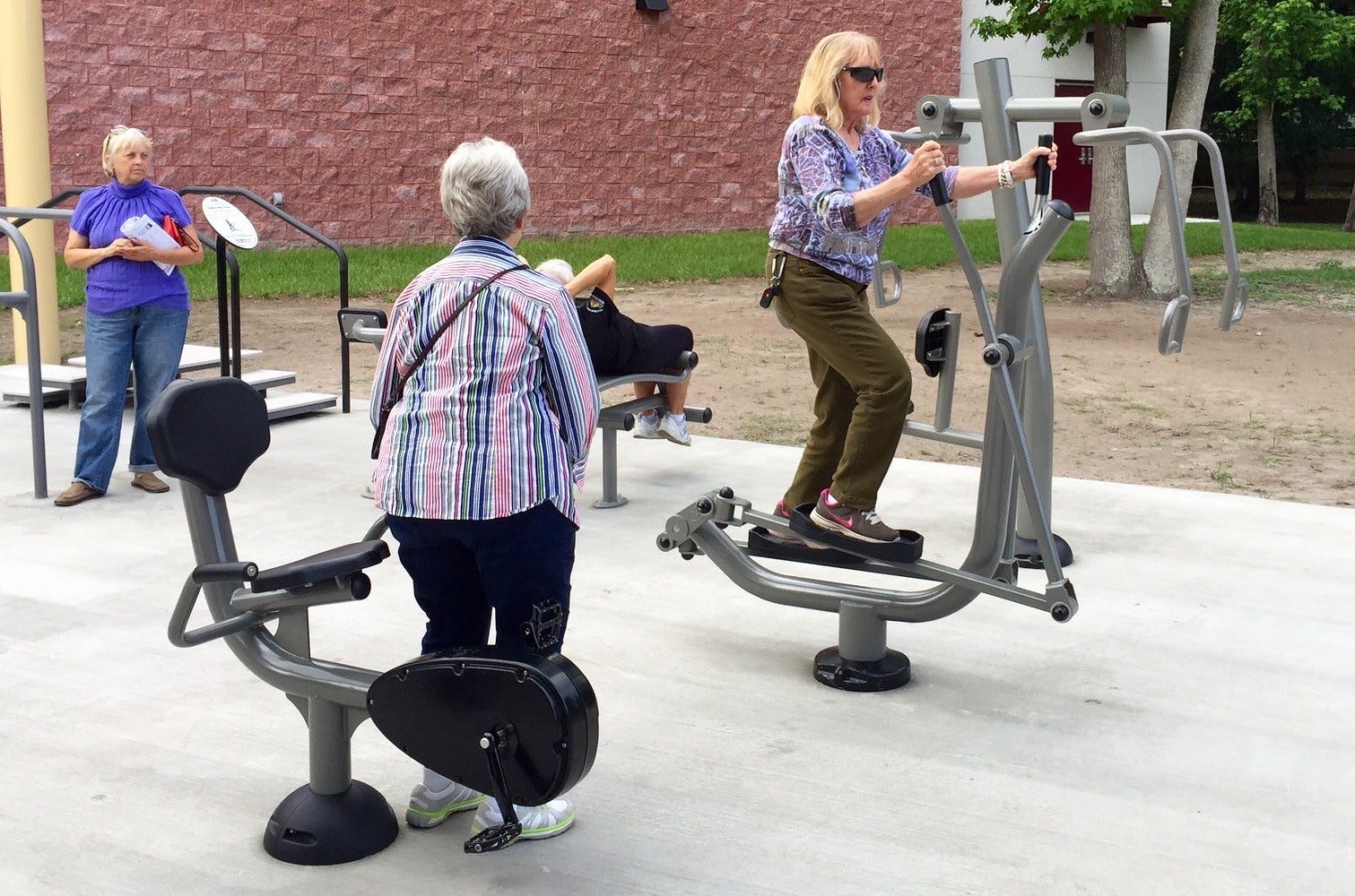 couple exercising outdoors equipment