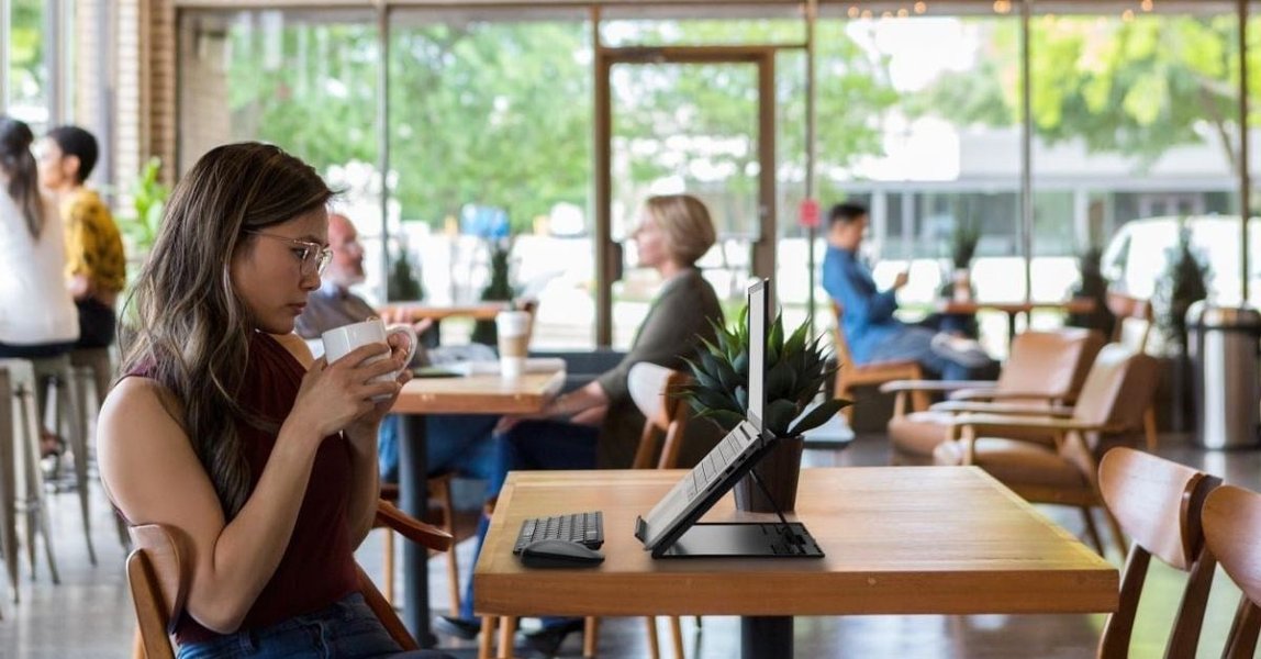Digital nomad working on a laptop with ergonomic accessories