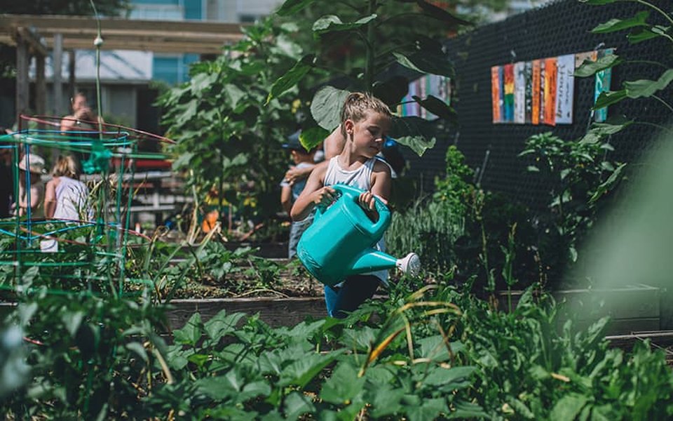 Person holding reusable water bottle outdoors