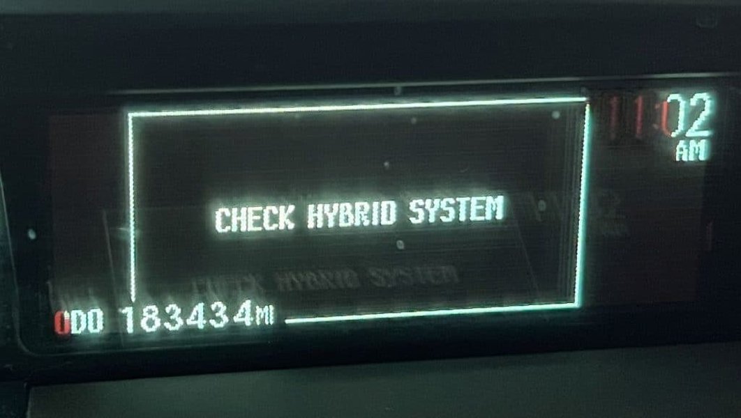 A typical "Check Hybrid System" warning light indicating a potential issue with the hybrid battery.