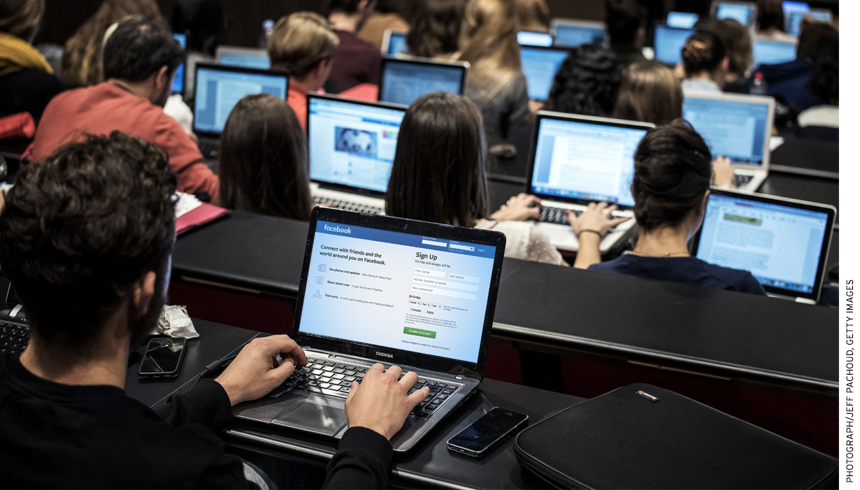 university campus with students working on computers