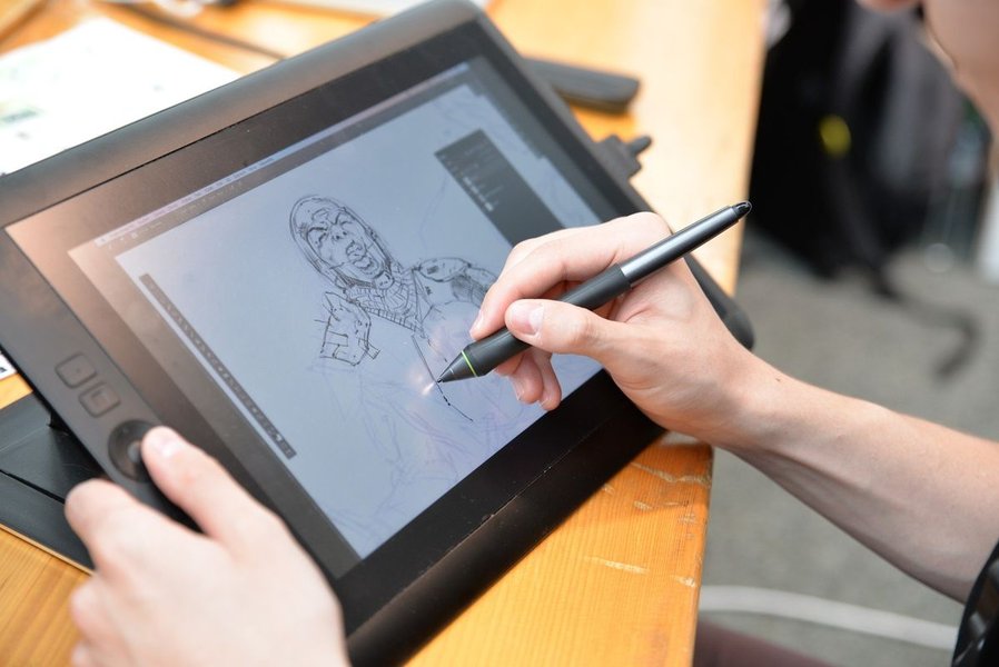 Artist using a drawing tablet with desktop software