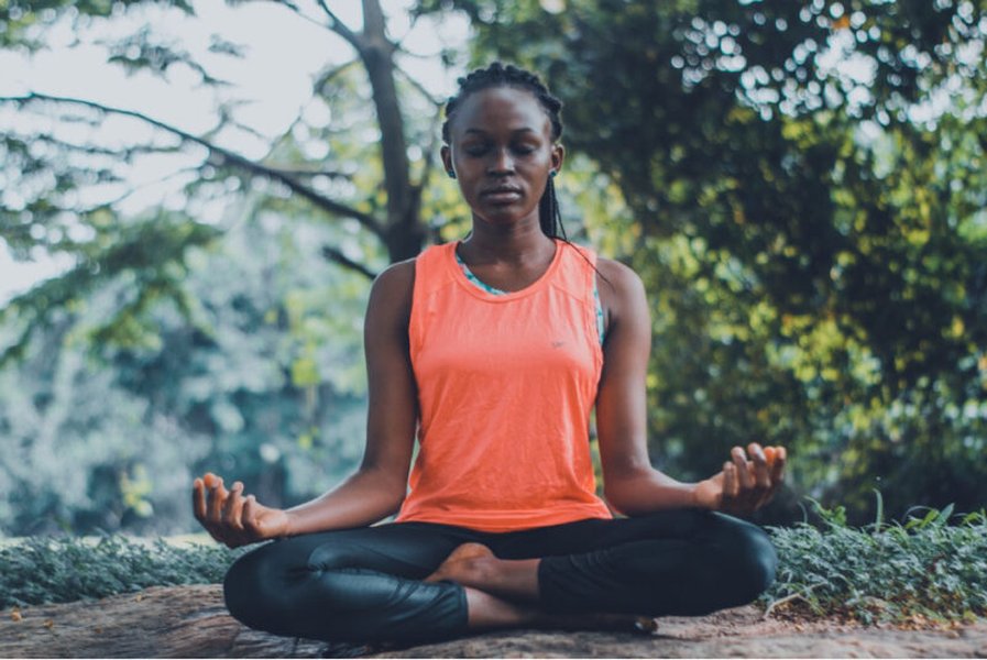 Person meditating peacefully outdoors