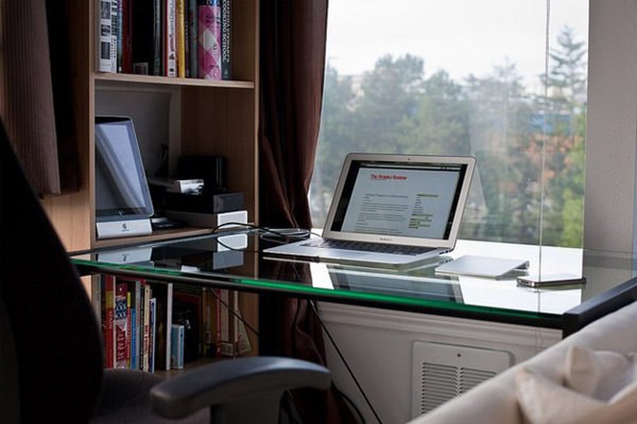 A developer's desk setup with multiple monitors displaying code and development tools.