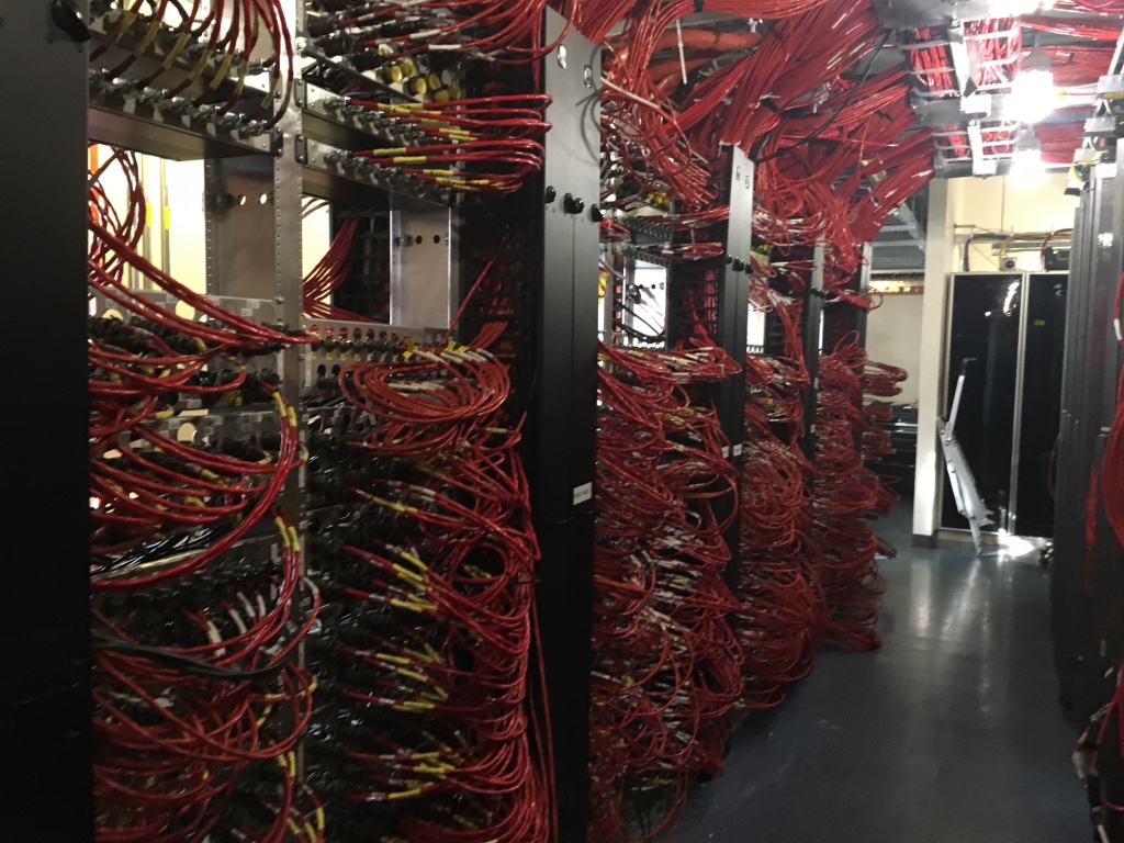 server room with desktop monitors and network cables