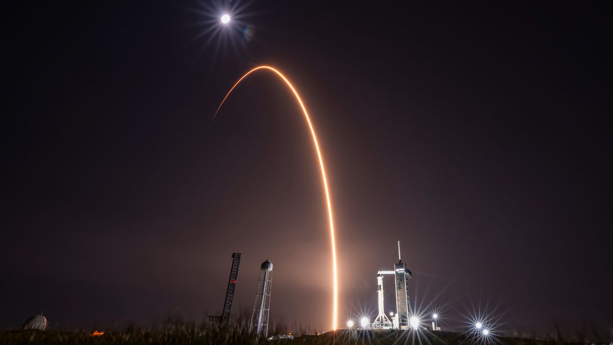 rocket launch at dusk, satellites in orbit