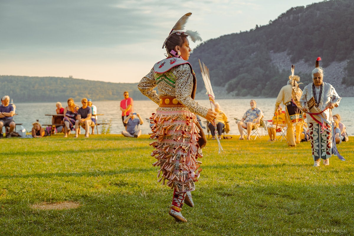 Indigenous cultural dance and basket weaving in natural setting