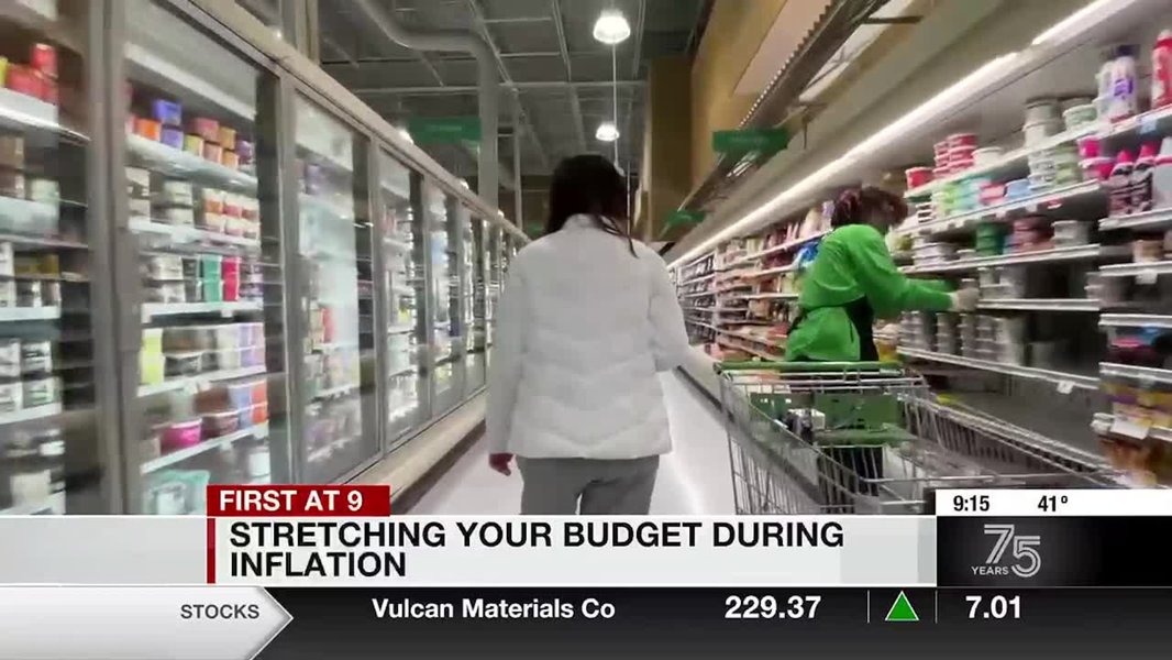 Person looking stressed while reviewing bills or budget