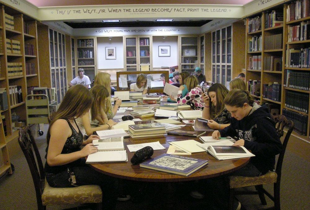 researchers in library with books