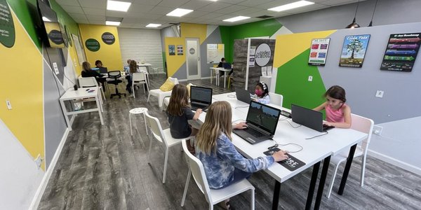 people coding in modern classroom
