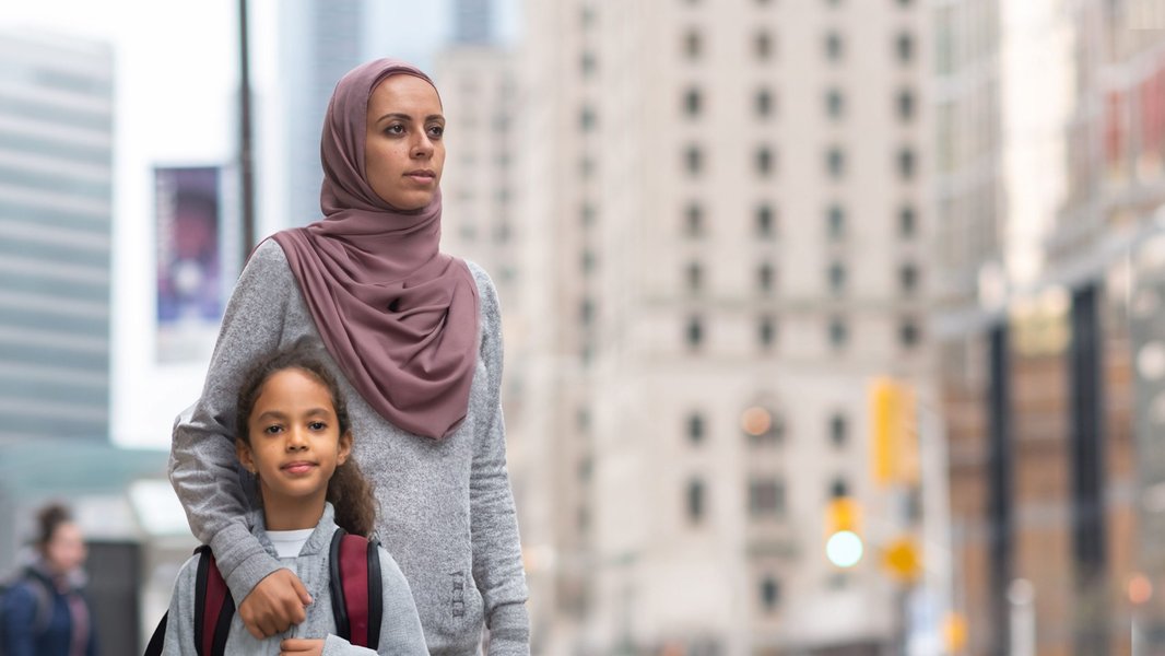 Muslim family engaging in an activity, fostering a supportive environment for children.