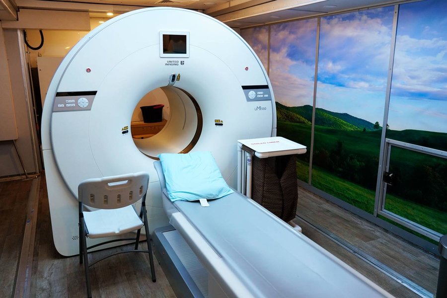 Technician monitoring PET scan results