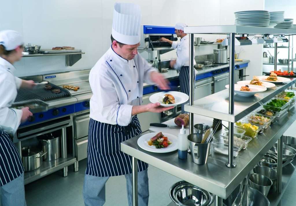 professional kitchen setup with chefs and equipment