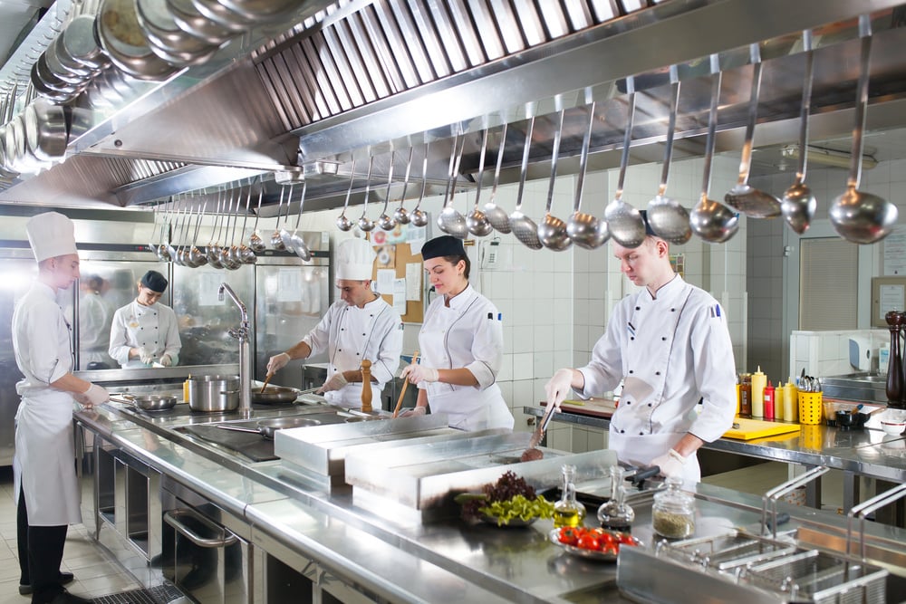 kitchen staff preparing meals, clean organized kitchen environment