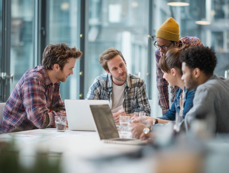 A team collaborating in a modern office environment, demonstrating the benefits of shared workspace.