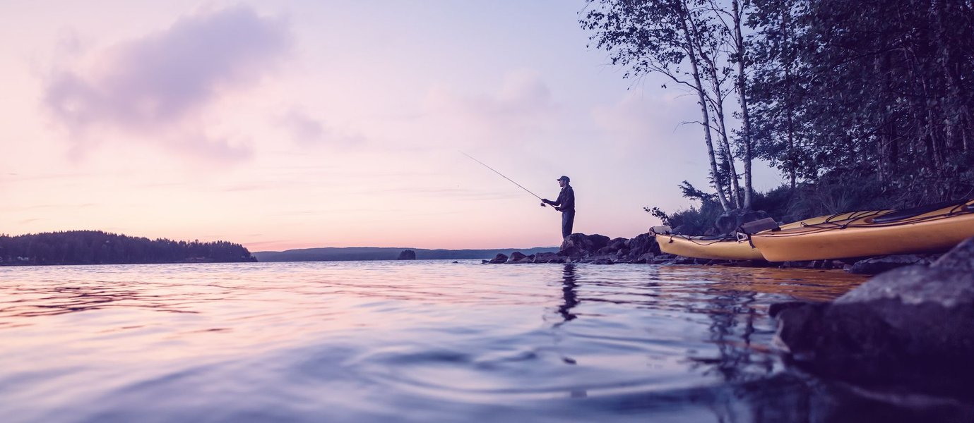 Person fishing from a boat on a lake