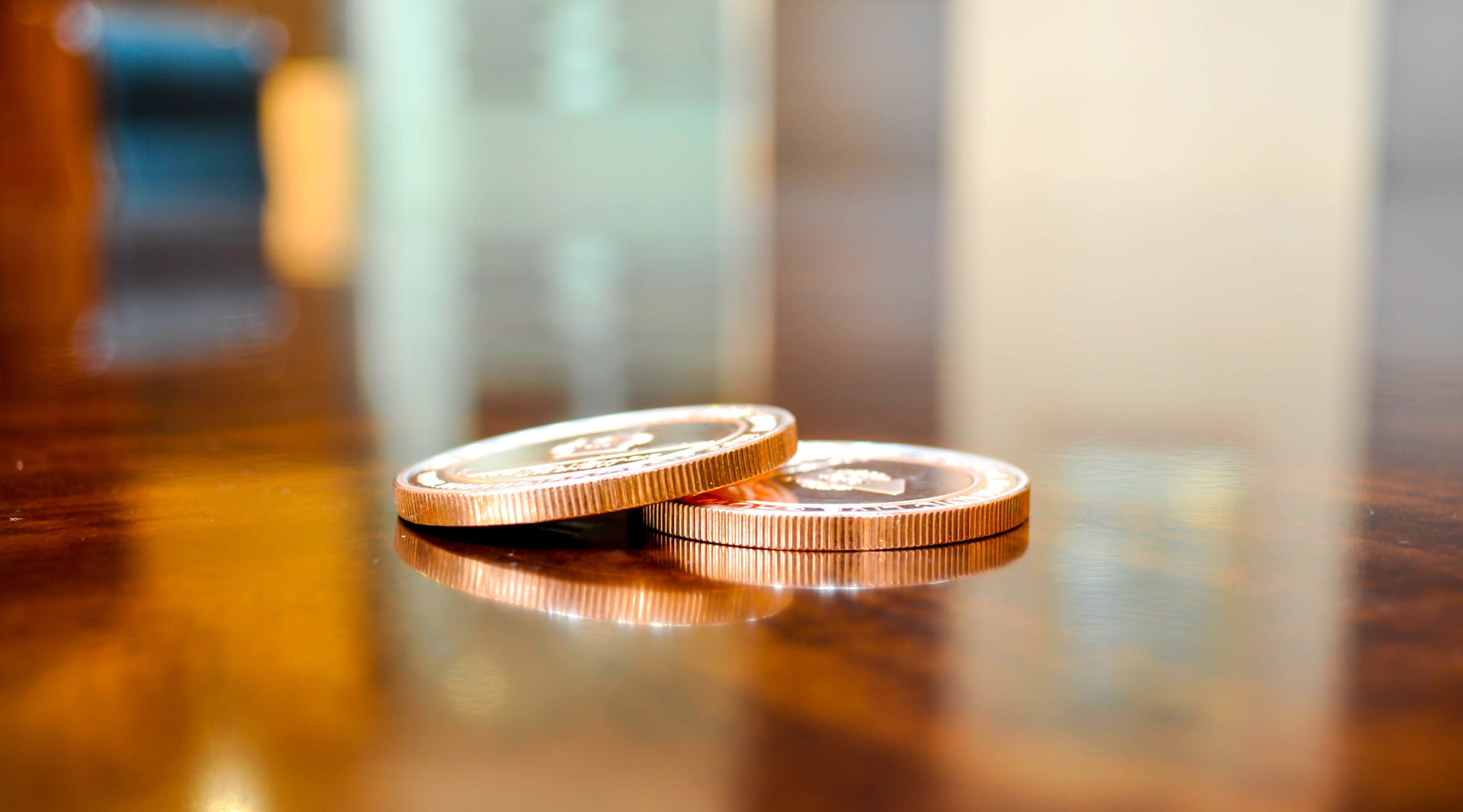 coins on table with light reflections