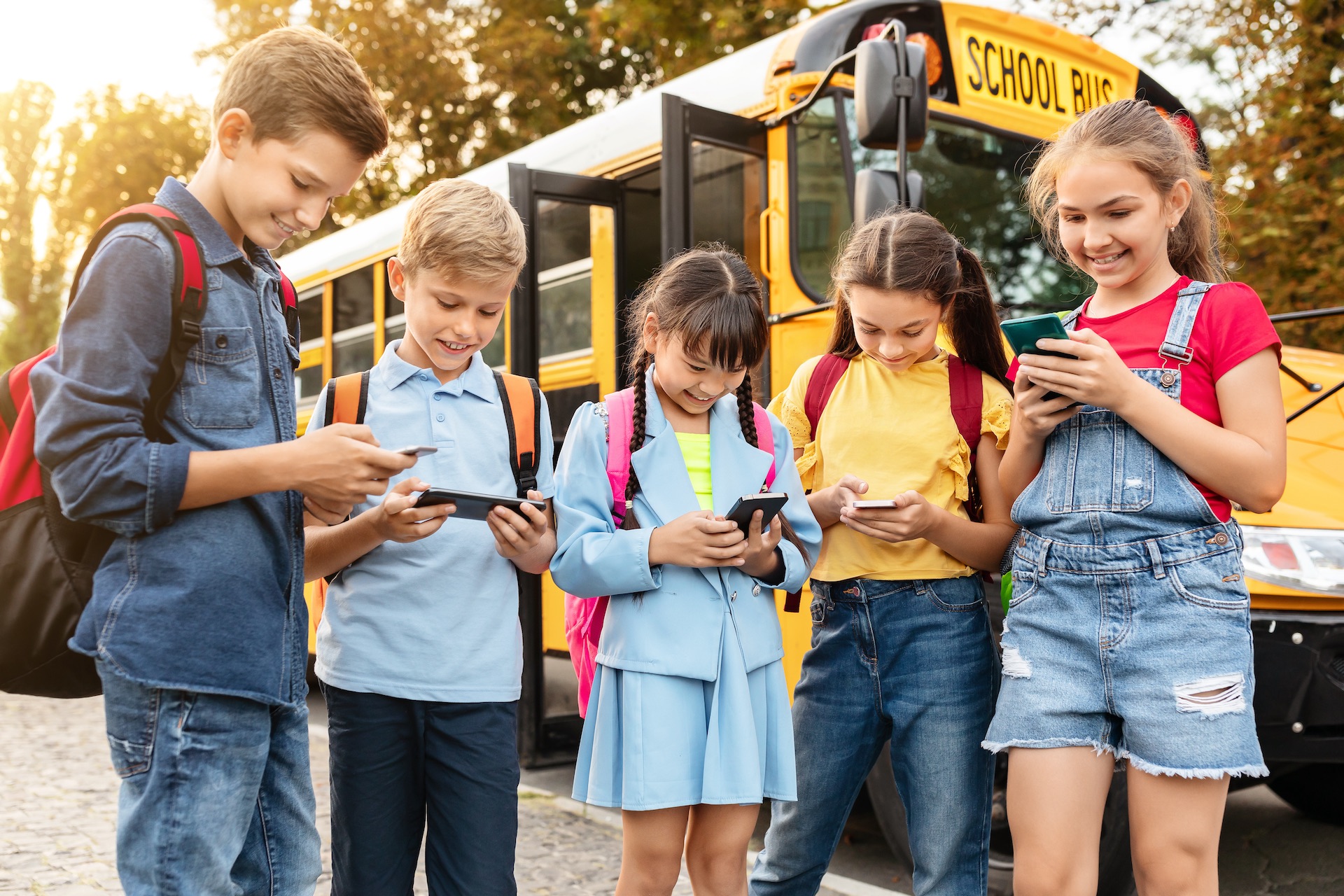students using smartphones outdoors