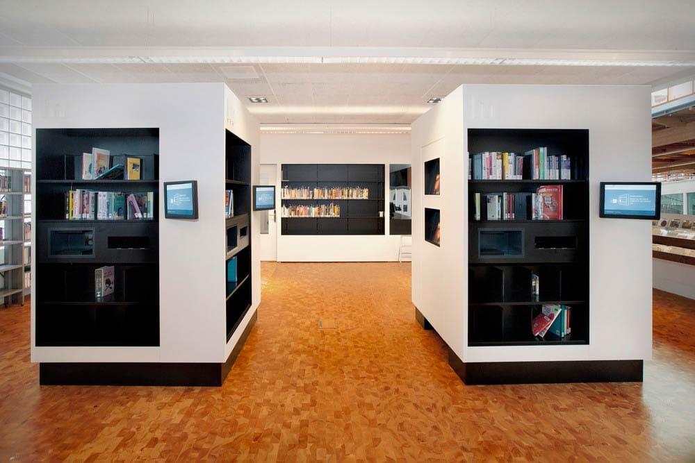 library shelving with books and RFID scanners