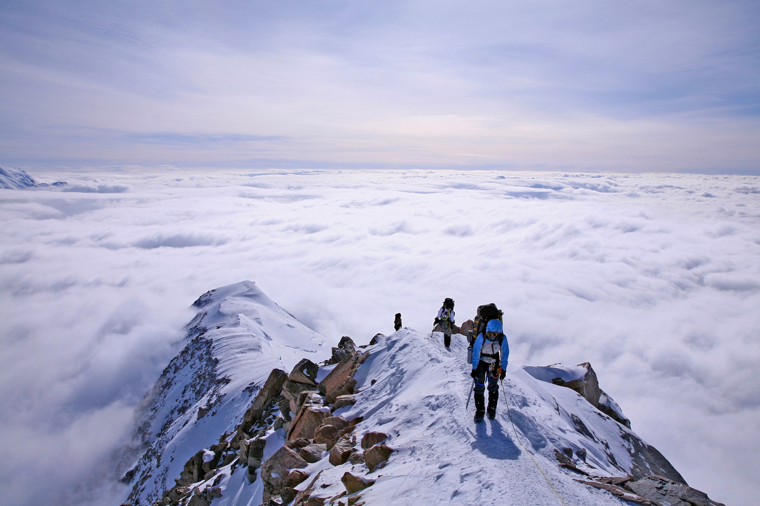 motivational scenery with people climbing mountain