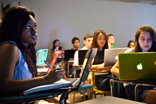 university campus, students studying with laptops