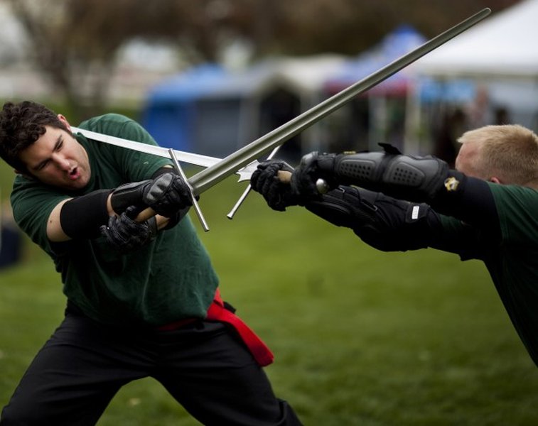 HEMA practitioners training with longswords, likely practicing binding and winding drills.