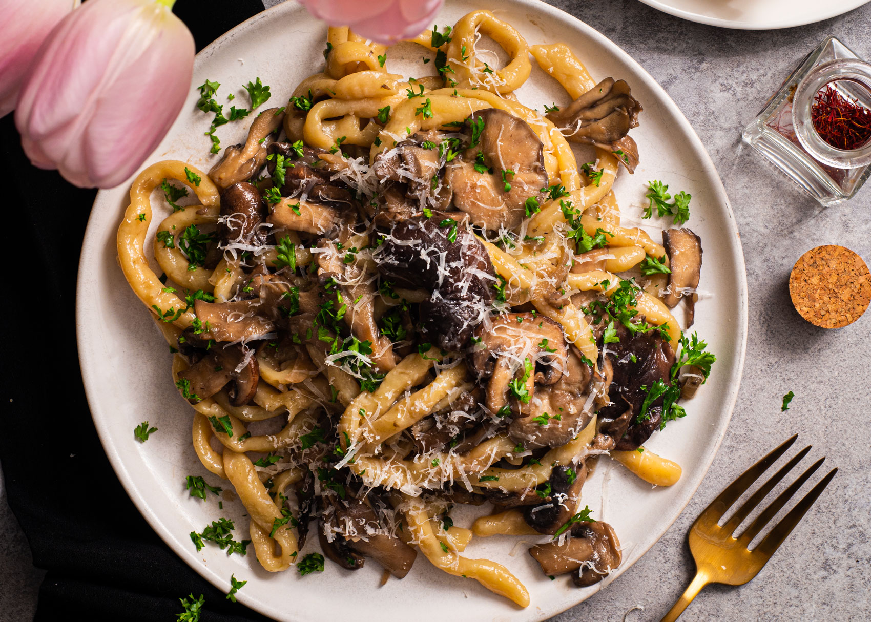 pasta dish with mushrooms and cream on a rustic table