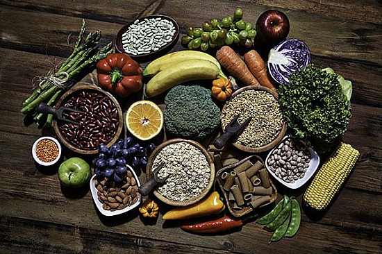 healthy food table full of fruits vegetables and whole grains