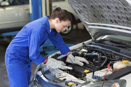 engine mechanic working on car engine