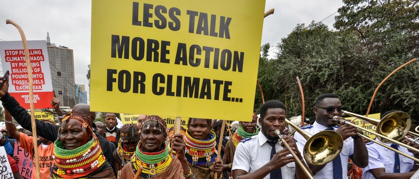 Climate protesters holding signs