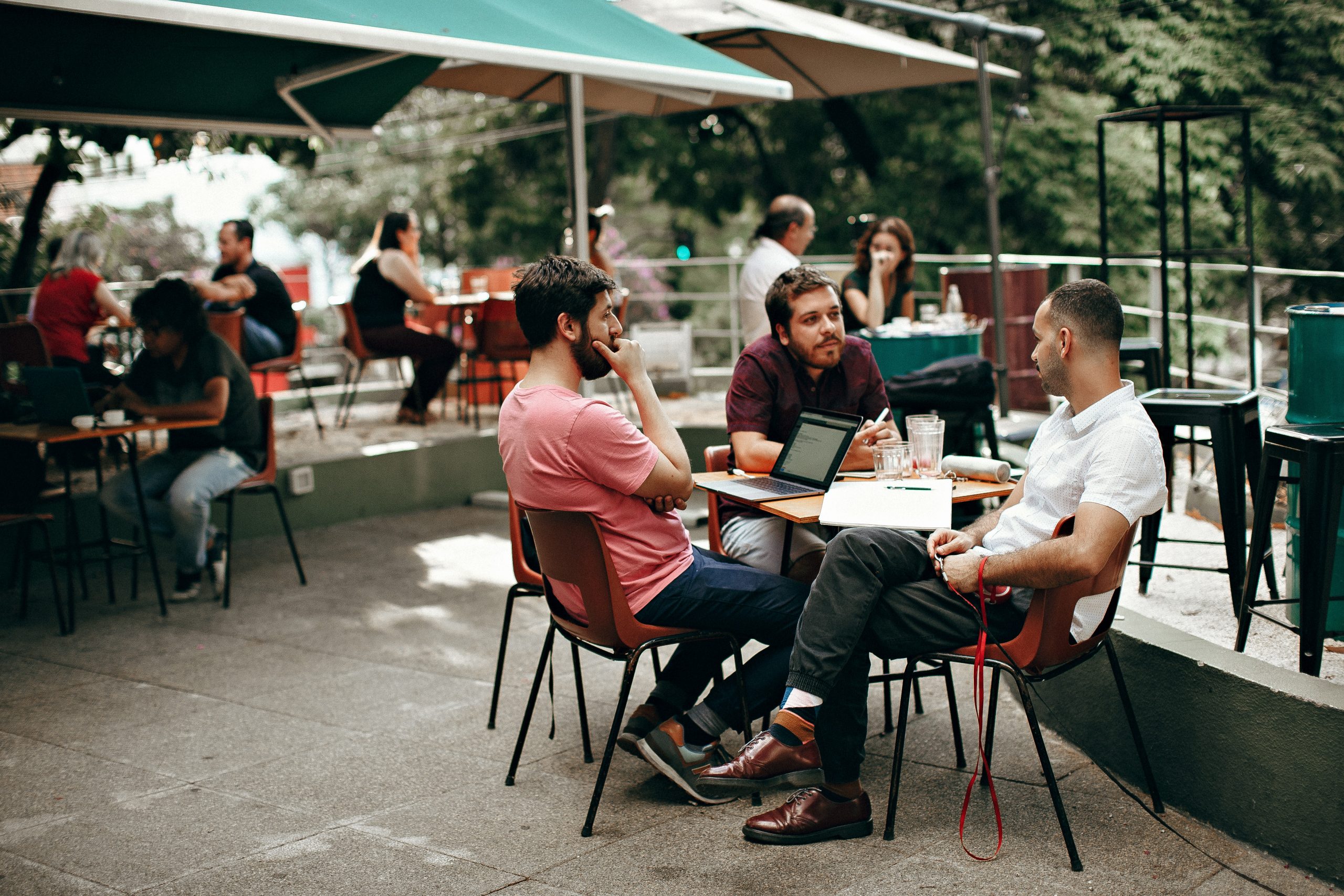 men engaging in conversation outdoors