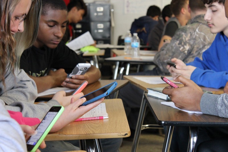 students using mobile devices in a classroom