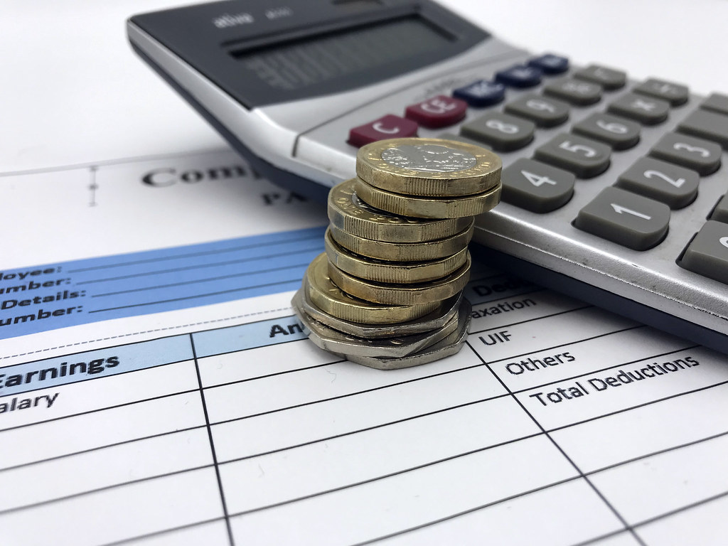coins with calculator and paper