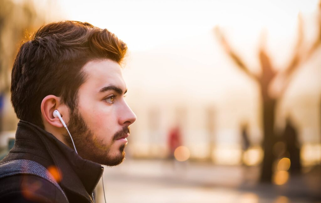 person waking up with headphones outdoors