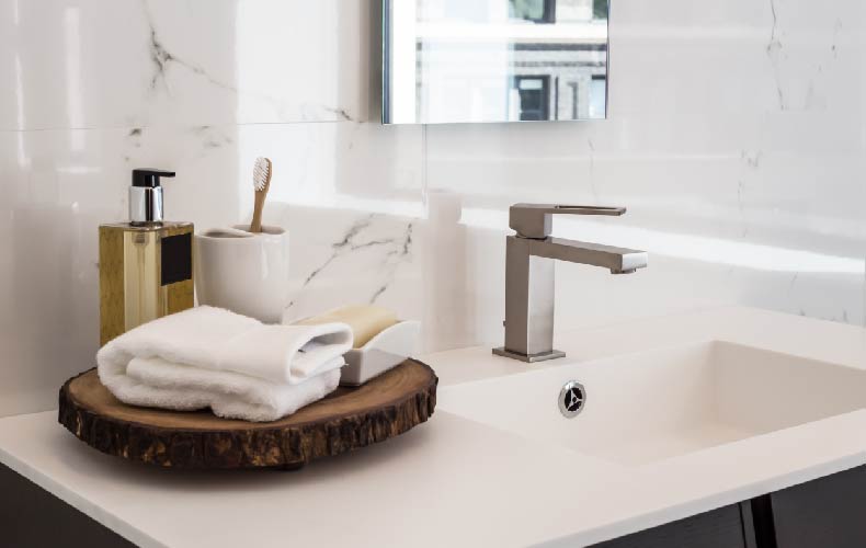 modern dental care equipment and toothpaste on a bathroom counter