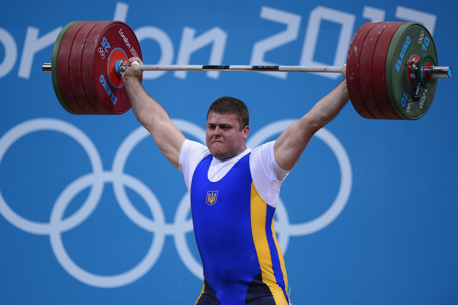 olympic athletes, weightlifting equipment, sports arena, physical training, competitive lifting