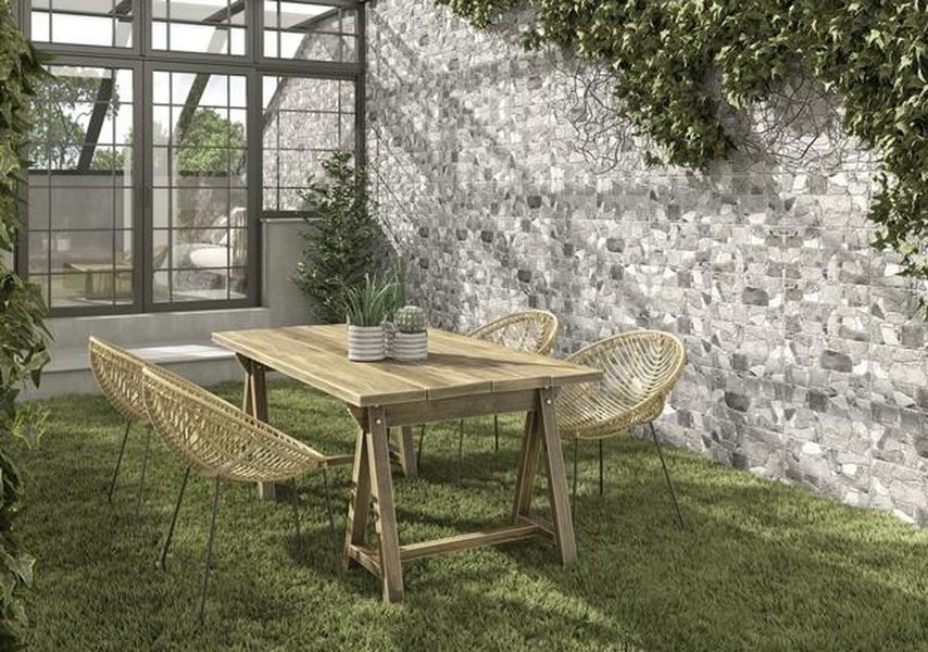 Modern outdoor tiled wall with large format tiles and integrated lighting.