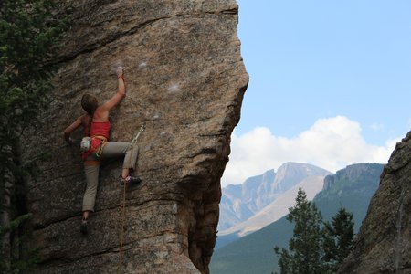 person climbing rocky mountain